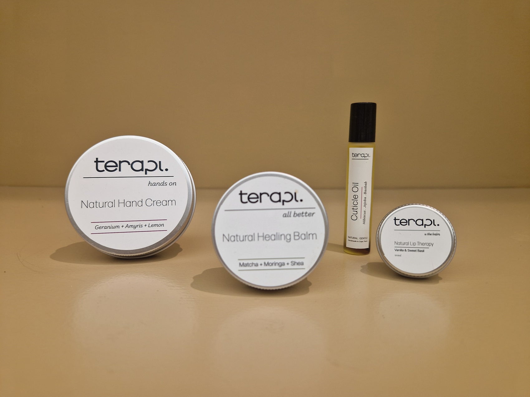 Collection of Terapi skincare products including cream, balm, and oil on a beige background
